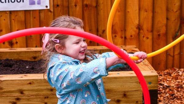 Child playing with hoop