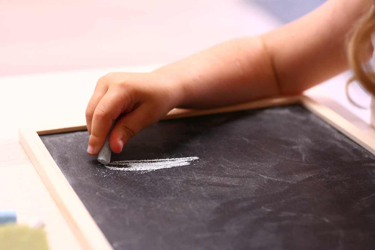 Child Mark Making on Blackboard