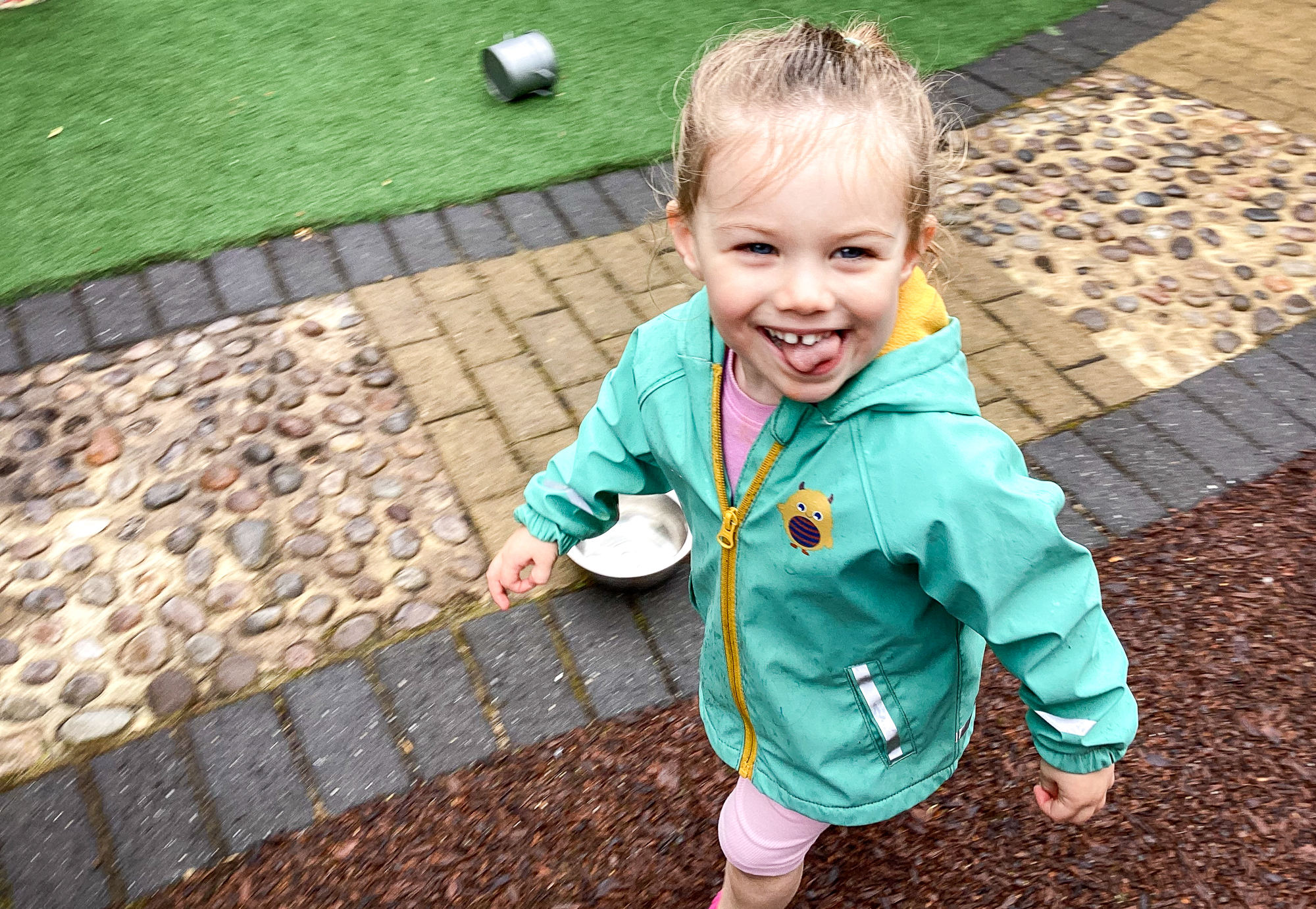 child smiling running in the rain